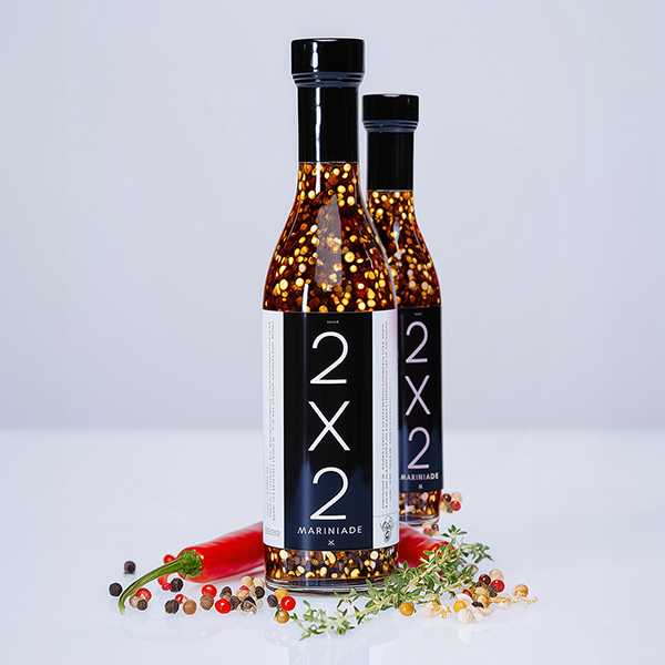 two bottles of "2x2" marinade, product photography